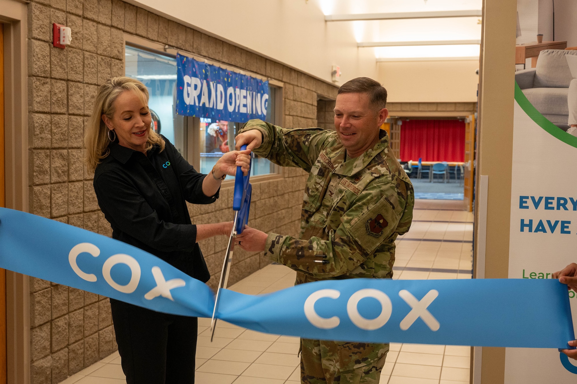 U.S. Air Force Col. Peter Abercrombie (right), 56th Mission Support Group commander, and Susan Anable (left, Cox Phoenix market vice president, cut a ribbon during a grand opening ceremony of the Luke Air Force Base Cox Innovation Lab, Feb. 23, 2024.