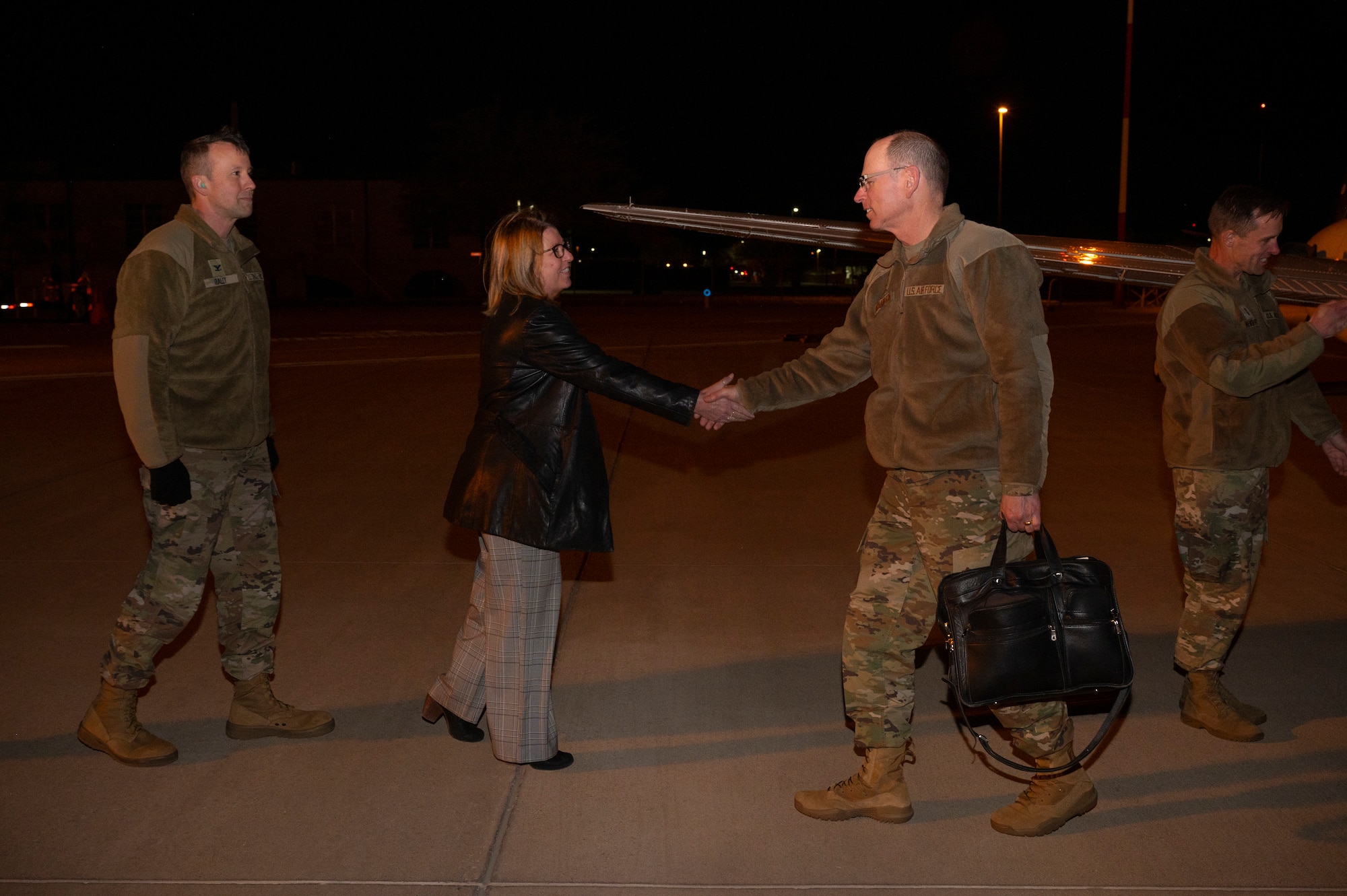 Man shakes woman's hand.