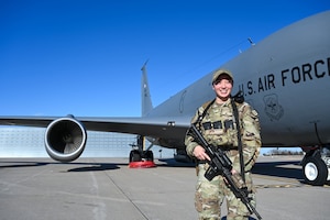 Staff Sgt. Amanda Estores, 22nd Security Forces Squadron patrolman, poses for a photo on the flightline Feb. 2, 2024 at McConnell Air Force Base, Kansas. Estores recently returned as McConnell’s first female Raven. (U.S. Air Force photo by Airman 1st Class William Lunn)