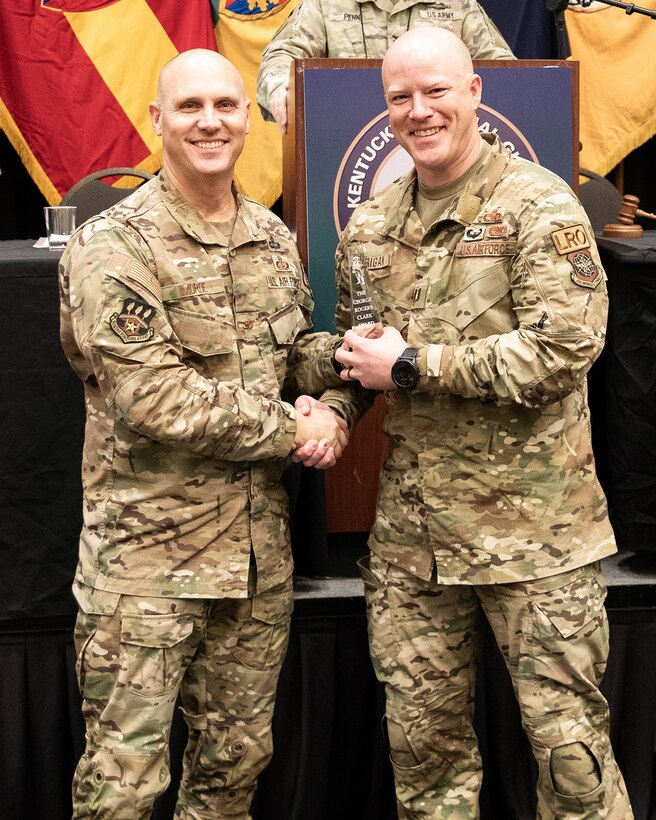 Capt. Matthew Hourigan, right, installation deployment officer for the Kentucky Air National Guard’s 123rd Logistics Readiness Squadron, receives the National Guard Association of Kentucky’s George Rogers Clark Outstanding Young Officer Award from Col. George Imorde, association president, during the organization’s annual conference in Bowling Green, Ky., Feb. 3, 2024. Hourigan led a complete re-write of the 123rd Airlift Wing’s Installation Deployment Plan, modernizing how the wing deploys for large-scale combat operations against peer and near-peer adversaries. (U.S. Army National Guard photo by Maj. Michael Reinersman)