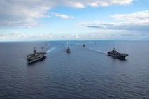 Ships from the Gerald R. Ford Carrier Strike Group (GRFCSG) and the Bataan Amphibious Ready Group (ARG), and Hellenic Navy frigate HS Navarinon (F 461) sail in formation in the Mediterranean Sea, Dec. 31, 2023. The ships from the GRFCSG include the first-in-class aircraft carrier USS Gerald R. Ford (CVN 78) and the Arleigh Burke-class guided-missile USS The Sullivans (DDG 68), USS Bulkeley (DDG 84), and USS Delbert D. Black (DDG 119). The ships from the Bataan ARG include the Wasp-class amphibious assault ship USS Bataan (LHD 5), the San Antonio Class-class amphibious transport dock USS Mesa Verde (LPD 19), Harpers Ferry-class dock landing ship USS Carter Hall (LSD 50). The U.S. maintains forward deployed, ready, and postured forces to deter aggression and support security and stability around the world. (U.S. Navy photo by Mass Communication Specialist Second Class Jacob Mattingly)