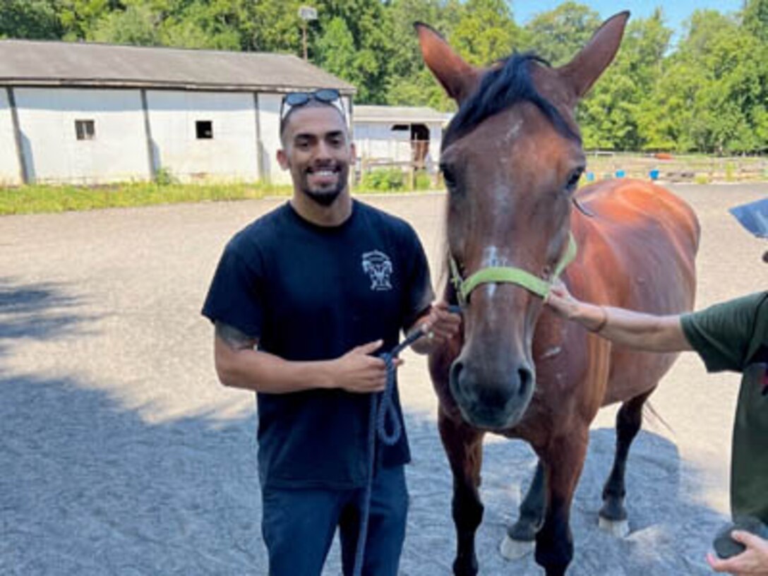 Courtesy Photo | (Photo courtesy CW2 Emmanuel Delgado) CW2 Delgado gets to know Batilda at the LETS program on August 23, 2023, in Northern Virginia.