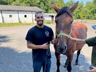 Courtesy Photo | (Photo courtesy CW2 Emmanuel Delgado) CW2 Delgado gets to know Batilda at the LETS program on August 23, 2023, in Northern Virginia.