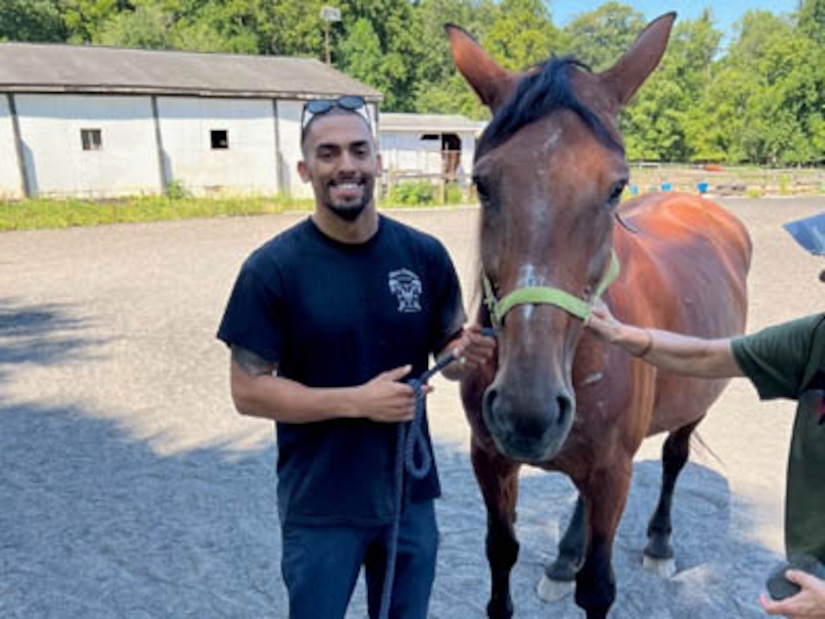 Courtesy Photo | (Photo courtesy CW2 Emmanuel Delgado) CW2 Delgado gets to know Batilda at the LETS program on August 23, 2023, in Northern Virginia.