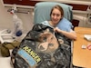 Photo By MaryTherese Griffin | (Photo courtesy Hannah Wright) 1st LT. Hannah Wright with a comfort quilt signed by members of her platoon before her second surgery at BAMC.