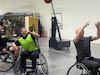 Courtesy Photo | (Photo courtesy Derrick Miller) Sgt. 1st Class Derrick Miller (in the middle) plays a little wheelchair basketball at the Fort Riley SRU.