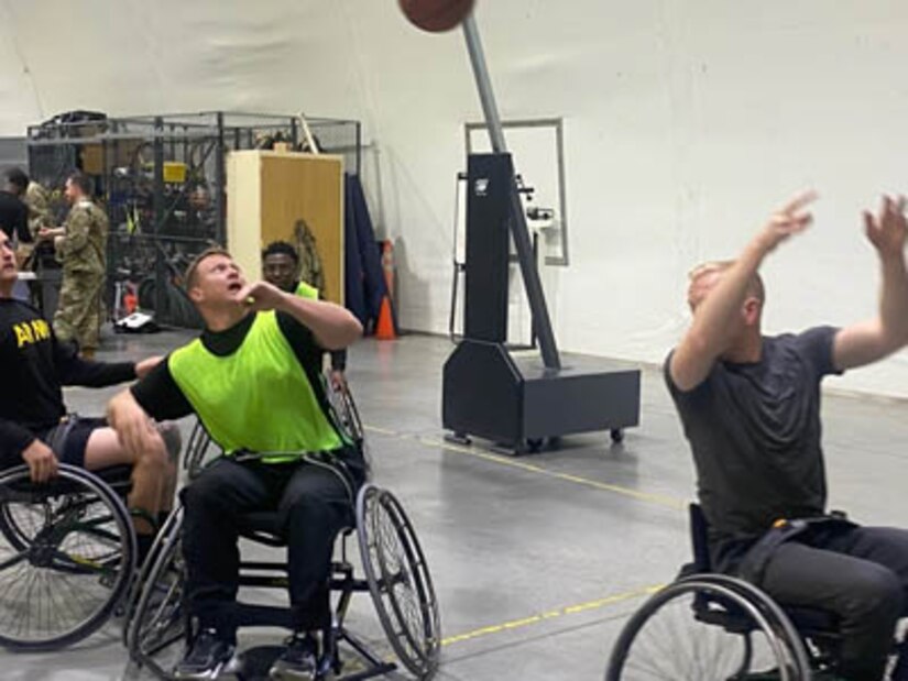 Courtesy Photo | (Photo courtesy Derrick Miller) Sgt. 1st Class Derrick Miller (in the middle) plays a little wheelchair basketball at the Fort Riley SRU.