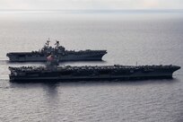 Ships from the Gerald R. Ford Carrier Strike Group (GRFCSG) and the Bataan Amphibious Ready Group (ARG), and Hellenic Navy frigate HS Navarinon (F 461) sail in formation in the Mediterranean Sea, Dec. 31, 2023. The ships from the GRFCSG include the first-in-class aircraft carrier USS Gerald R. Ford (CVN 78) and the Arleigh Burke-class guided-missile USS The Sullivans (DDG 68), USS Bulkeley (DDG 84), and USS Delbert D. Black (DDG 119). The ships from the Bataan ARG include the Wasp-class amphibious assault ship USS Bataan (LHD 5), the San Antonio Class-class amphibious transport dock USS Mesa Verde (LPD 19), Harpers Ferry-class dock landing ship USS Carter Hall (LSD 50). The U.S. maintains forward deployed, ready, and postured forces to deter aggression and support security and stability around the world. (U.S. Navy photo by Mass Communication Specialist 3rd Class Maxwell Orlosky)