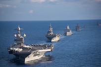 Ships from the Gerald R. Ford Carrier Strike Group (GRFCSG) and the Bataan Amphibious Ready Group (ARG), and Hellenic Navy frigate HS Navarinon (F 461) sail in formation in the Mediterranean Sea, Dec. 31, 2023. The ships from the GRFCSG include the first-in-class aircraft carrier USS Gerald R. Ford (CVN 78) and the Arleigh Burke-class guided-missile USS The Sullivans (DDG 68), USS Bulkeley (DDG 84), and USS Delbert D. Black (DDG 119). The ships from the Bataan ARG include the Wasp-class amphibious assault ship USS Bataan (LHD 5), the San Antonio Class-class amphibious transport dock USS Mesa Verde (LPD 19), Harpers Ferry-class dock landing ship USS Carter Hall (LSD 50). The U.S. maintains forward deployed, ready, and postured forces to deter aggression and support security and stability around the world. (U.S. Navy photo by Mass Communication Specialist 3rd Class Maxwell Orlosky)