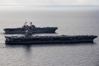 Ships from the Gerald R. Ford Carrier Strike Group (GRFCSG) and the Bataan Amphibious Ready Group (ARG), and Hellenic Navy frigate HS Navarinon (F 461) sail in formation in the Mediterranean Sea, Dec. 31, 2023. The ships from the GRFCSG include the first-in-class aircraft carrier USS Gerald R. Ford (CVN 78) and the Arleigh Burke-class guided-missile USS The Sullivans (DDG 68), USS Bulkeley (DDG 84), and USS Delbert D. Black (DDG 119). The ships from the Bataan ARG include the Wasp-class amphibious assault ship USS Bataan (LHD 5), the San Antonio Class-class amphibious transport dock USS Mesa Verde (LPD 19), Harpers Ferry-class dock landing ship USS Carter Hall (LSD 50). The U.S. maintains forward deployed, ready, and postured forces to deter aggression and support security and stability around the world. (U.S. Navy photo by Mass Communication Specialist 3rd Class Maxwell Orlosky)