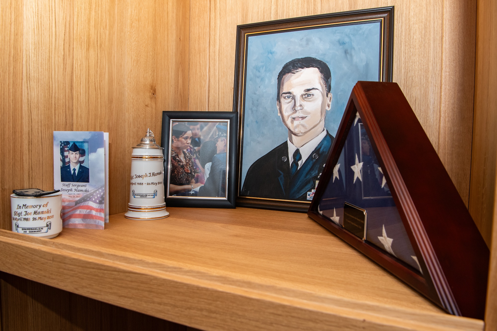 A display committed to the memory of U.S. Air Force Staff Sgt. Joseph J. Hamski greets visitors entering the 52nd Civil Engineer Squadron Explosive Ordnance Disposal flight facility at Spangdahlem Air Base, Germany, Dec. 1, 2023. The facility is dedicated to Hamski, an EOD technician who was assigned to Spangdahlem AB when he was killed in action in May 2011. (U.S. Air Force photo by Staff Sgt. Max J. Daigle)