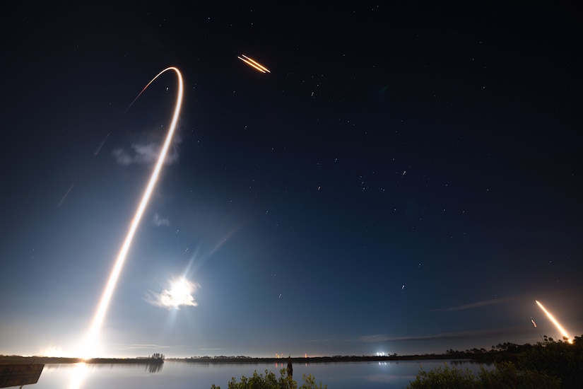 A rocket is launched into space at night.