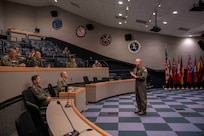 Rear Admiral Max McCoy, commander, Carrier Strike Group Four (CSG-4) speaks with Tactical Training Group, Atlantic (TTGL) staff on Aug. 11, 2023 as part of a welcoming tour.