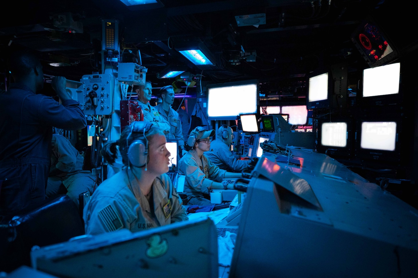 Sailors assigned to the Arleigh Burke-class guided-missile destroyer USS Carney (DDG 64) stand watch in the ship’s Combat Information Center during an operation to defeat a combination of Houthi missiles and unmanned aerial vehicles, Oct. 19.