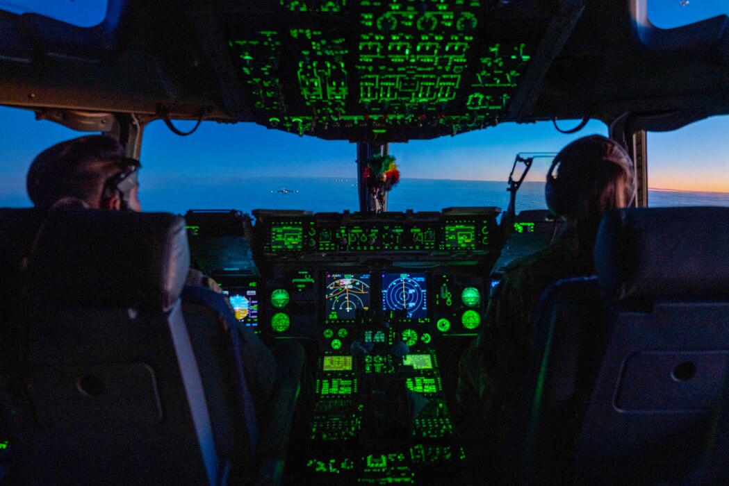 U.S. Air Force Lt. Col. Ollney Hoopai III, 204th Airlift Squadron pilot and 1st Lt. Cassidy Mullen, 535th Airlift Squadron pilot, conducts a C-17 Globemaster III airdrop mission during the Joint Pacific Multinational Readiness Center 24-1 over Malemute Drop Zone, Alaska, Nov. 2, 2023. The Joint Pacific Multinational Readiness Center (JPMRC) is the Army's newest Combat Training Center (CTC and generates readiness in the environments and conditions where our forces are most likely to operate in. JPMRC 24-1 includes over 5,300 training participants from across the U.S. Joint Force, New Zealand, the United Kingdom, Indonesia, and Thailand. (U.S. Air National Guard photo by Mysti Bicoy)