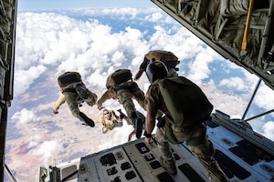 A French special operator jumps out of a plane cargo ramp during parachute training.