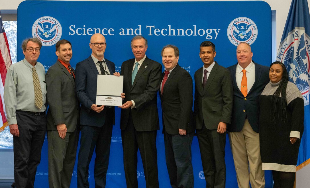 Left to Right: Pete Devlin, Dept. of Energy; Nick Josefik, USACE ERDC CERL; Ronald Langhelm, DHS S&T; Dr. Dimitri Kusnezov, Under Secretary of DHS Science and Technology Directorate (S&T); Zachary Kittrie, FEMA; Prateek Vaish, Accelera by Cummins; Chris Steinhilber, Support Contractor - DHS S&T; Kathryn Grazionale, Support Contractor - DHS S&T.
