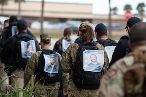 Members of the Air Force Office of Special Investigation Detachment 802 and 45th Security Forces Squadron gathered for a ruck march in memory of joint patrol team Hustler 6 at Patrick Space Force Base, Florida, Dec. 21, 2023.