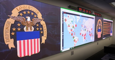 Picture of the DLA logo and a large screen with a map