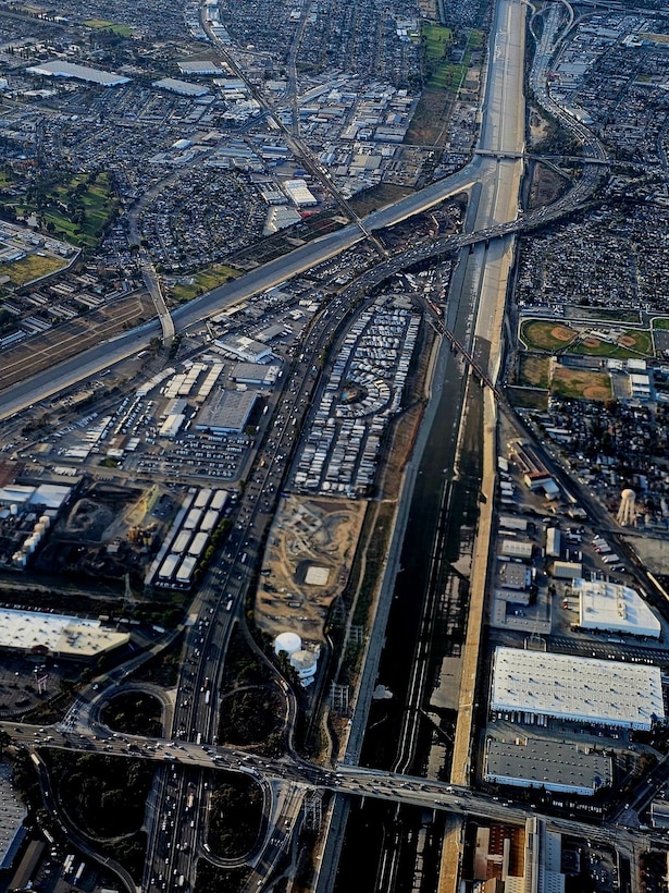 Pictured is an aerial view of portions of the Los Angeles River. The U.S. Army Corps of Engineers Los Angeles District has several roles in operating, maintaining and regulating the LA River, as well as managing federal lands. Under the Los Angeles County Drainage Area project, the Corps operates and maintains several dams and portions of the river's channels and tributaries. The river flows through seven different congressional districts, 10 city council districts, 20 neighborhood councils and 12 community-planned areas.