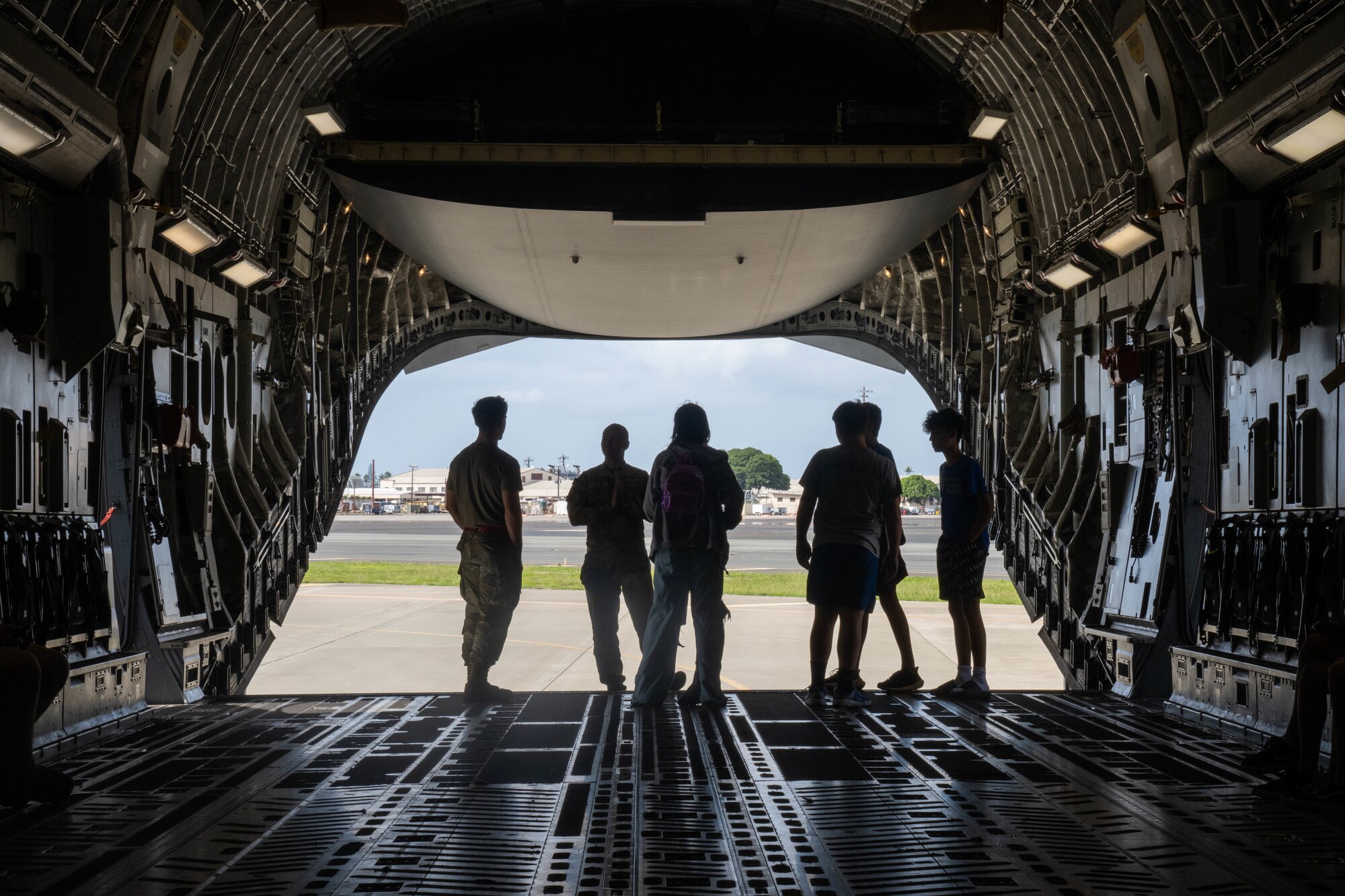 Airmen stand in aircraft.