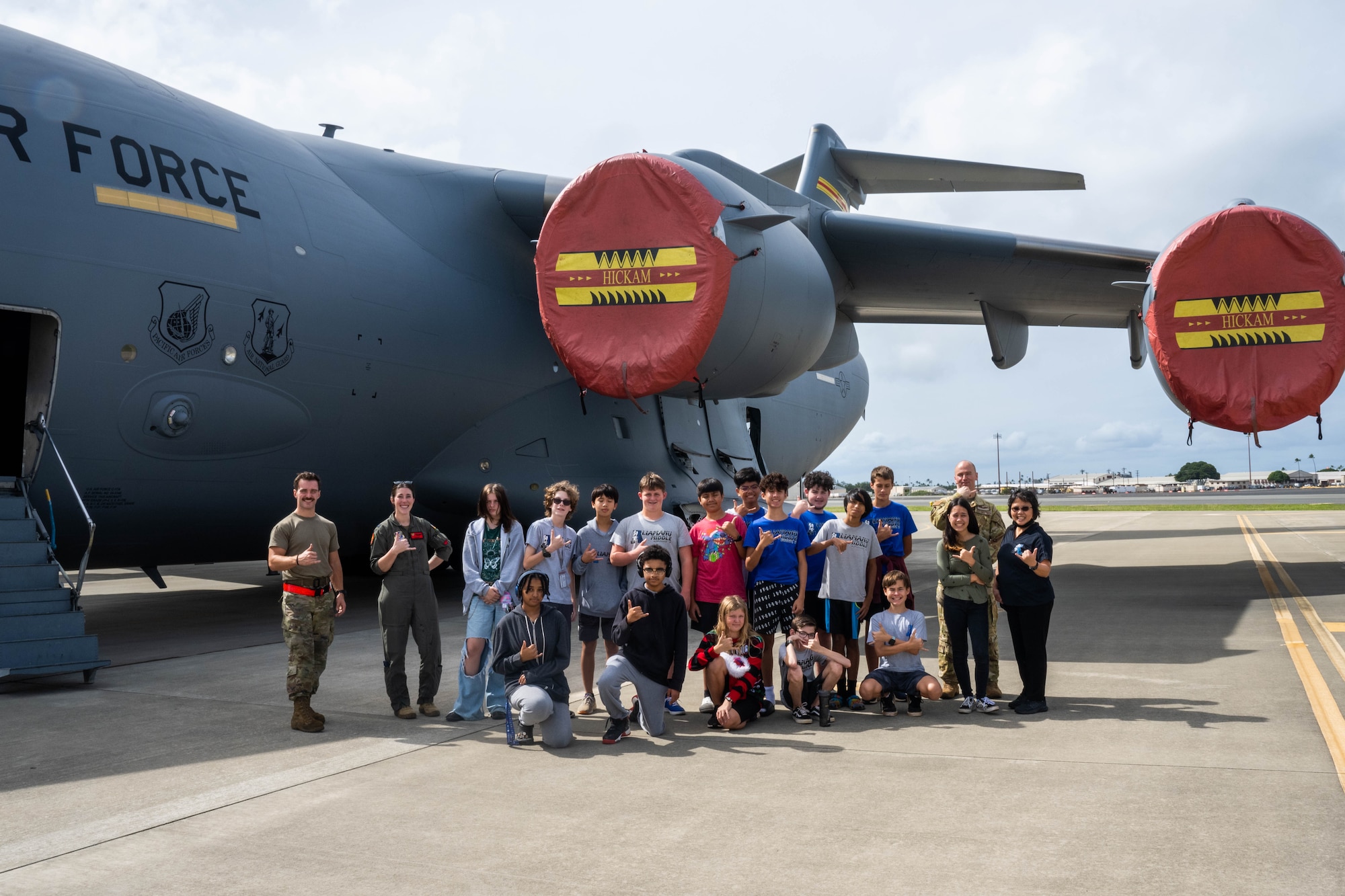 Airmen and students pose for a photo.