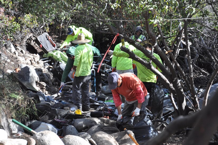 Workers contracted by the U.S. Army Corps of Engineers Los Angeles District remove trash and debris from the riverbed of the San Gabriel River Dec. 4 near Azusa, California. The cleanup took place over a three-week period after bird-nesting season ended.