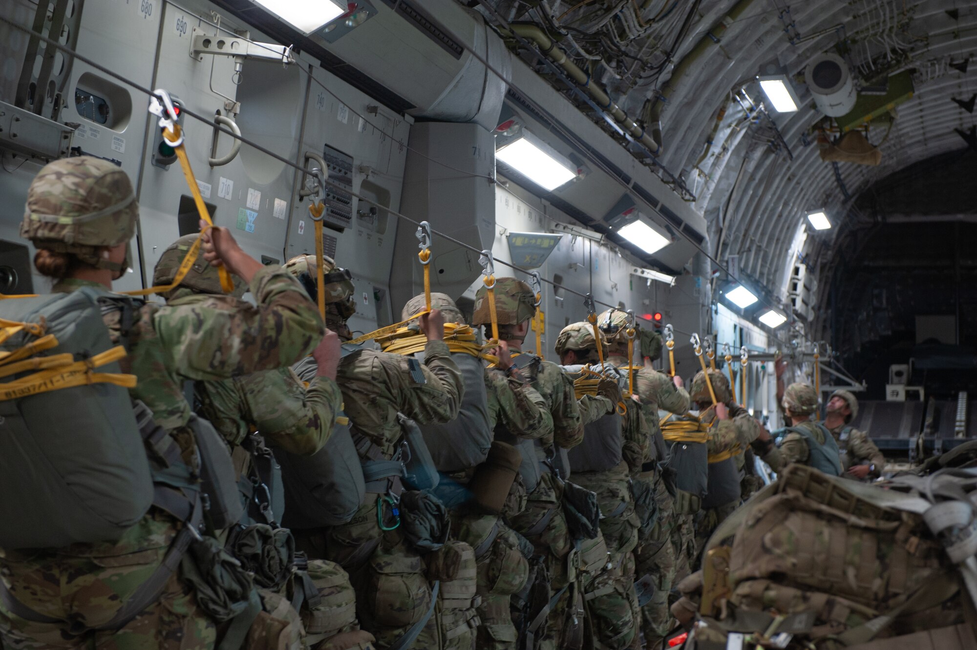 U.S. Army Soldiers from the 1st Squadron (Airborne) 40th Cavalry Regiment prepare to jump from a U.S. Air Force C-17 Globemaster III assigned to the 204th Airlift Squadron over Anchorage, Alaska as part of a training exercise for the Joint Pacific Multinational Readiness Center Nov. 2, 2023. JPMRC trains forces in the environments and conditions where they are most likely to operate. JPMRC keeps trained and ready forces aggregated and available in theater for Joint and Combined training, but also capable to respond to crisis or conflict. (U.S. Air National Guard photo by Airman 1st Class Roann Gatdula)