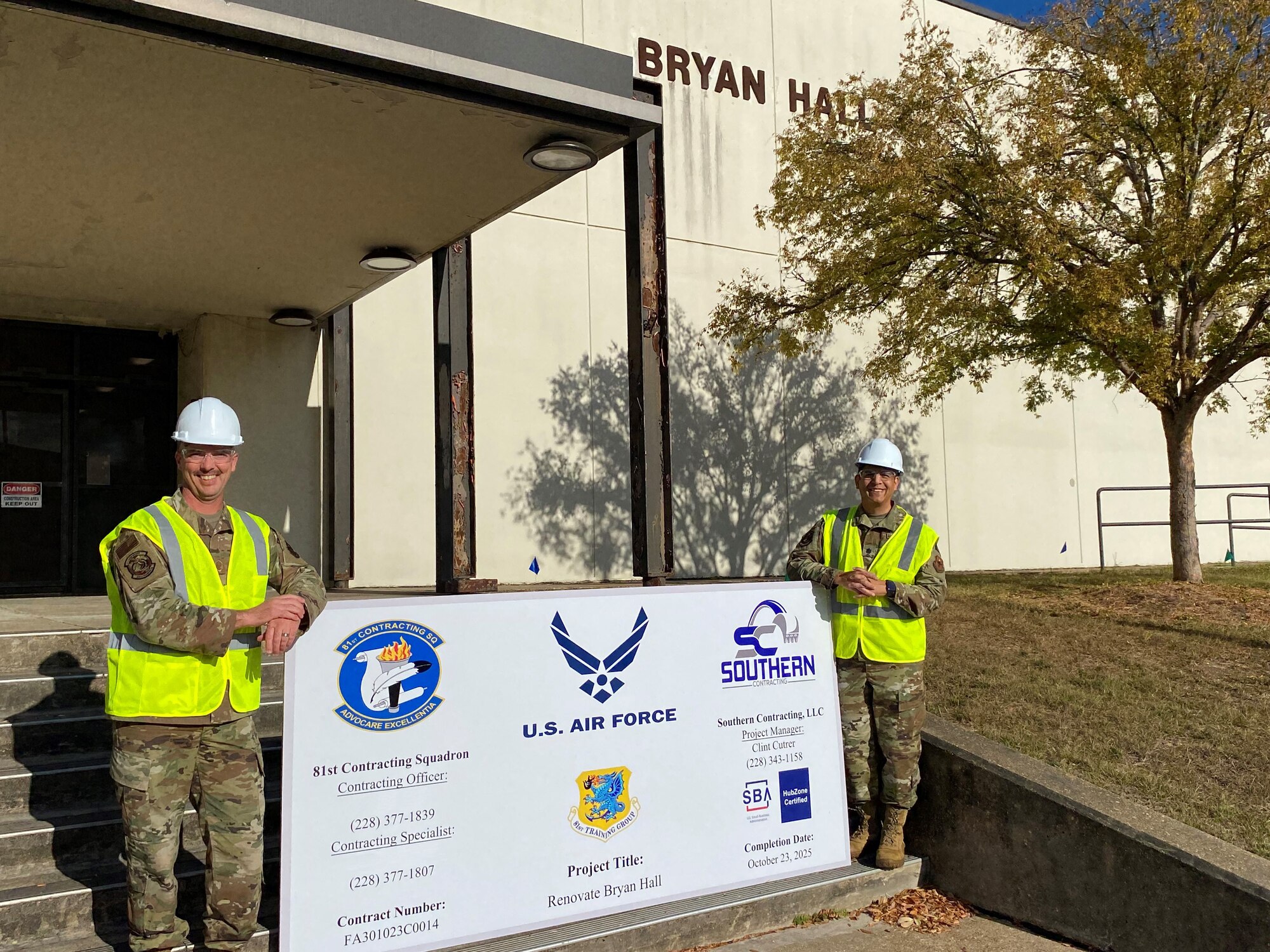 U.S. Air Force Lt. Col. Neftali Herrada, 338th Training Squadron commander, and Master Sgt. Jonathan McCullar, 338th TRS Network System Operations flight chief, pose for a photo in front of Bryan Hall on Keesler Air Force Base, Mississippi, Dec. 6, 2023.