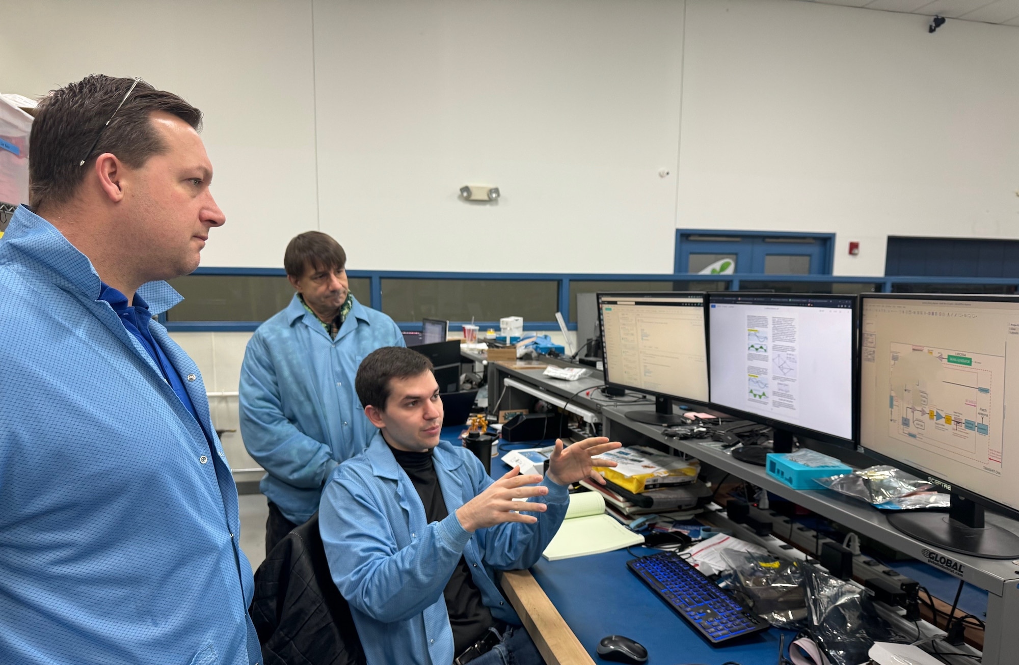 David Bair, center, senior engineer at Converge Technologies in Hilliard, Ohio, briefs Dr. Aaron Jones, front, president of Raider Technologies, on a radio frequency board layout for a low-cost, size, weight and power, or low C-SWaP, radar prototype at a Converge Technologies lab while Daryl Popig, senior Hardware and Software engineer at Converge Technologies observes. Jones, a previous graduate of the Air Force Research Laboratory, or AFRL’s, Entrepreneur Opportunity Program, described the program as “the most unique technology transition and tech startup opportunity in the country for defense and dual-use companies and one of the top benefits for AFRL scientists and engineers.” Raider Technologies and Converge Technologies are collaborating on an Air Force Small Business Innovation Research topic for low C-SWaP radar for Air Traffic Control and have collaborated with AFRL’s Small Business office. (Courtesy photo)