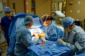 Navy medical professionals perform a vascular arm surgery on a local Palauan resident at the Belau National Hospital in Koror, Palau.