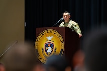 Sergeant Major of the Army gives a speech behind an Army Recruiting and Retention College podium