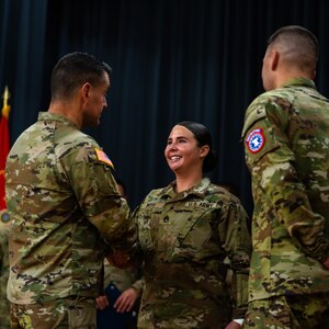 Sergeant Major of the Army in uniform promotes female Soldier in uniform