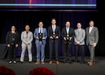Department of Defense (DOD) ManTech Director Tracy Frost and DoD ManTech Deputy Director Keith Devries presents U.S. Naval Research Laboratory (NRL) researcher, (fourth from right) Kevin Cronin a Technology Achievement Award for delivering Lightweight Hydrogen Fuel Cells for Unmanned Aerial Systems (UAS) solutions to the Department of Defense with Office of the Secretary of Defense (OSD) ManTech Program Manager and project sponsor Justin McRoberts; Dr. Adam Jolley, a team member and awardee from the Naval Air Warfare Center Aircraft Division; Tim Klein, an industry team member and awardee from Northwest UAV; and OSD ManTech Deputy Program Manager and project sponsor Dr. Steve Recchia at the Defense Manufacturing Conference held in Nashville, Tenn., Dec. 11, 2023. (U.S. Navy photo)