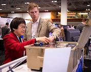 U.S. Naval Research Laboratory (NRL) researcher Kevin Cronin from the Chemistry Division’s Alternative Energy Section shows Under Secretary of Defense for Research and Engineering Heidi Shyu NRL's Hydrogen Fuel Cell Technology for Unmanned Aerial Systems research efforts during the Defense Manufacturing Conference held in Nashville, Tenn., Dec 14. NRL’s Hydrogen Small Unit Power (H-SUP) prototype offers a low signature solution for electric power production, up to 1.2 kW of continuous power, in a ruggedized package. (U.S. Navy photo)