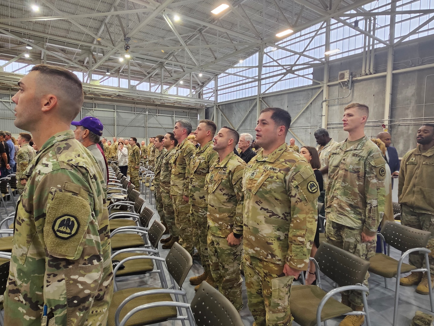 Soldiers of the 1-244th Assault Helicopter Battalion sing the Army Song during a deployment ceremony at the Army Aviation Support Facility #1 in Hammond, Louisiana, Dec. 2, 2023. Over 70 Soldiers will deploy to Kosovo to support a NATO-led peacekeeping mission.