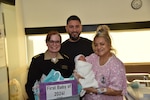 Walter Reed National Military Medical Center director U.S. Navy Capt. (Dr.) Melissa Austin presented a gift basket to Hector and Angelina Navarro to commemorate the birth of their son Azarias, the first baby born in the hospital in 2024.