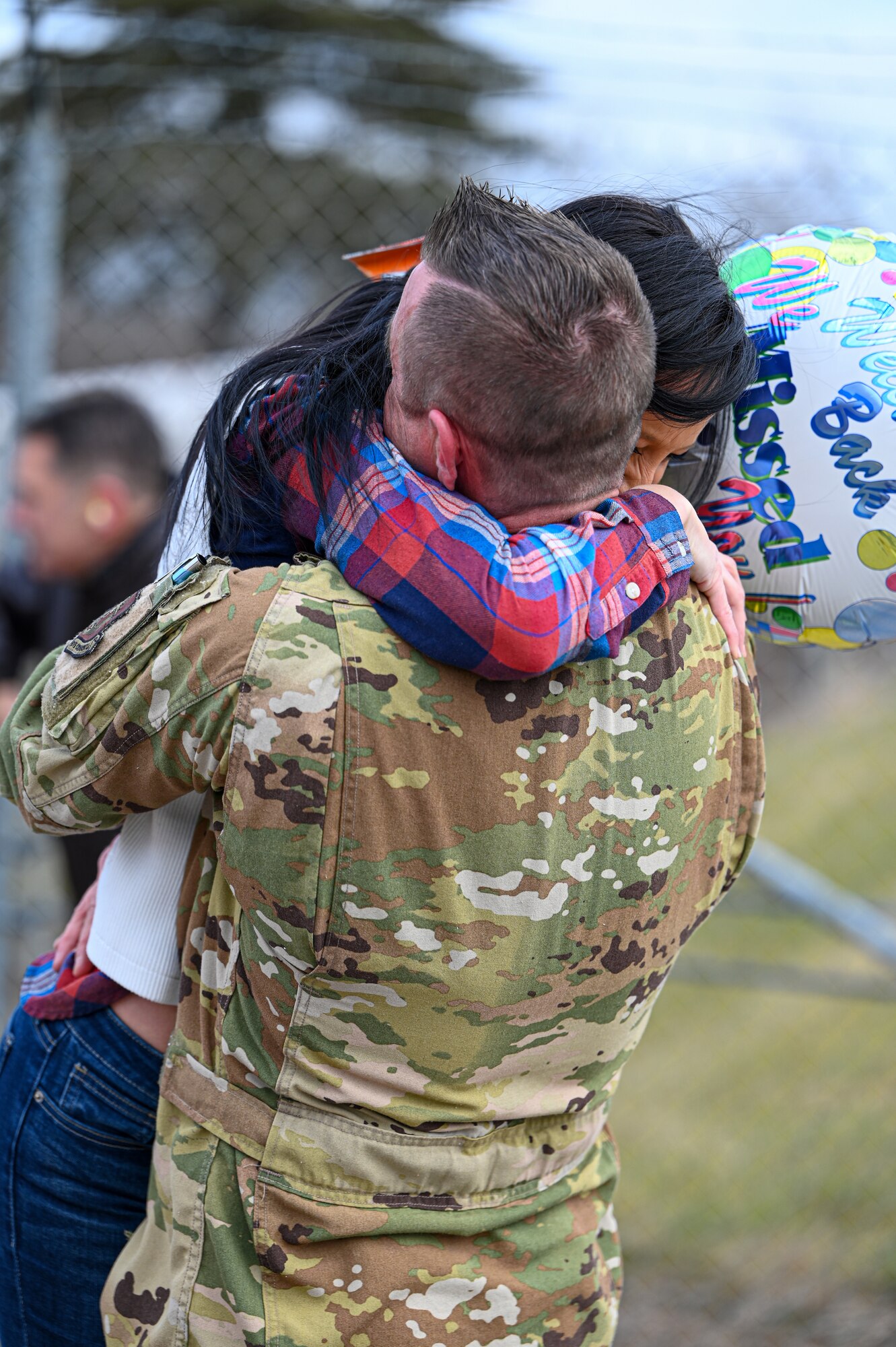 A Reserve Citizen Airmen with the 445th Airlift Wing reunites with a family member at Wright-Patterson Air Force Base, Ohio, Jan. 4, 2024. The Airmen returned from a two-month deployment where they transported cargo, personnel and humanitarian aid to various locations. (U.S. Air Force photo by Master Sgt. Patrick O’Reilly)