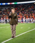 U.S. Army North 323d Army Band vocalist continues her service as she shares her talents by singing the National Anthem at a football game in Seattle, Wa. on Dec 1, 2023.