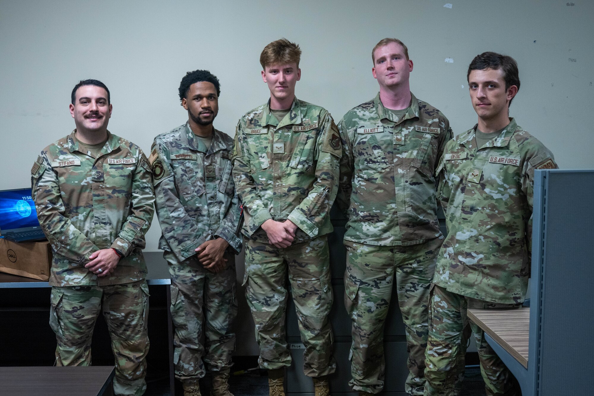Airmen pose for a photo.