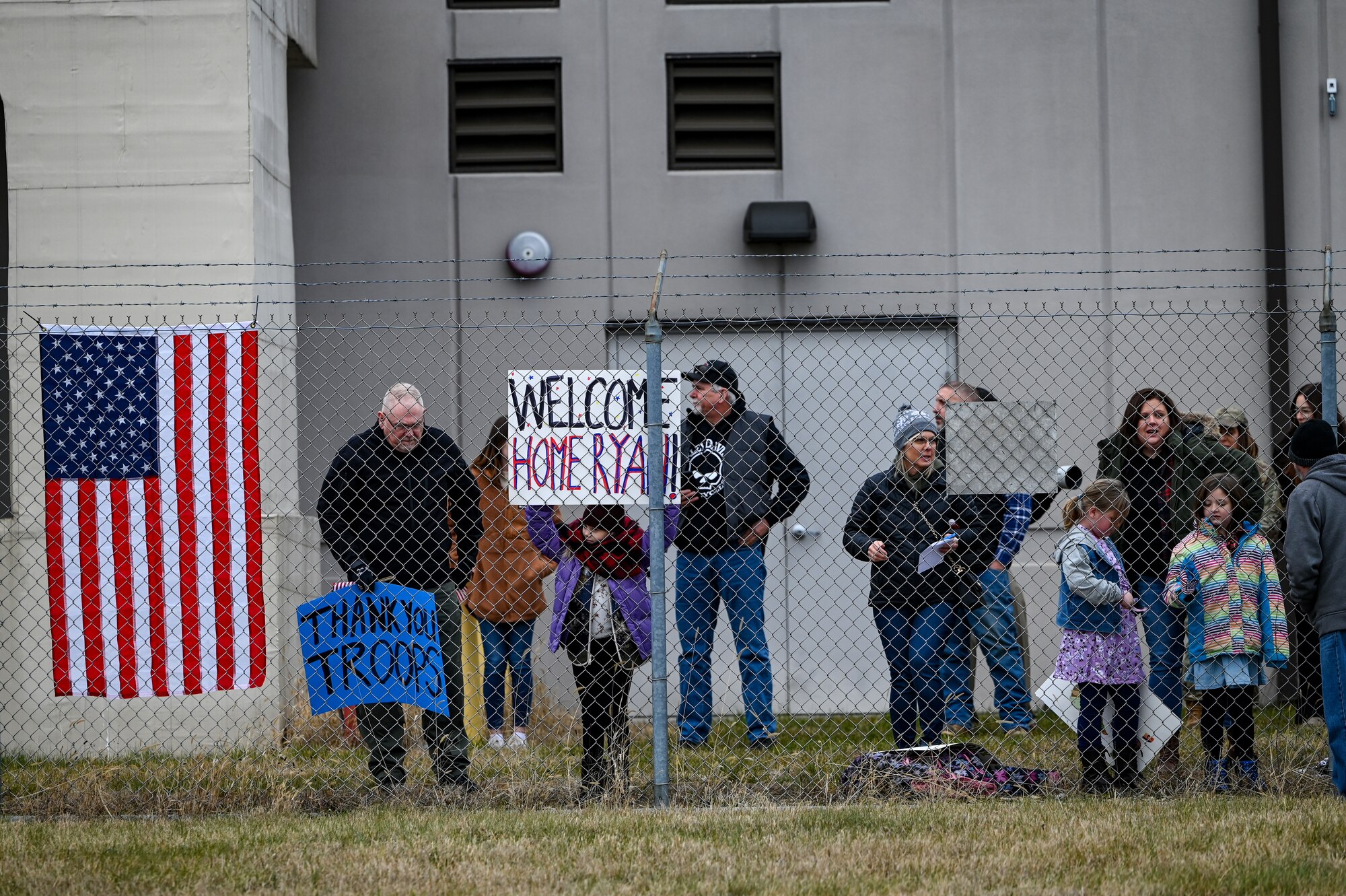 Family and friends wait to welcome home 445th Airlift Wing Reserve Citizen Airmen at Wright-Patterson Air Force Base, Ohio, Jan. 4, 2024. The Airmen returned from a two-month deployment where they transported cargo, personnel and humanitarian aid to various locations. (U.S. Air Force photo by Master Sgt. Patrick O’Reilly)