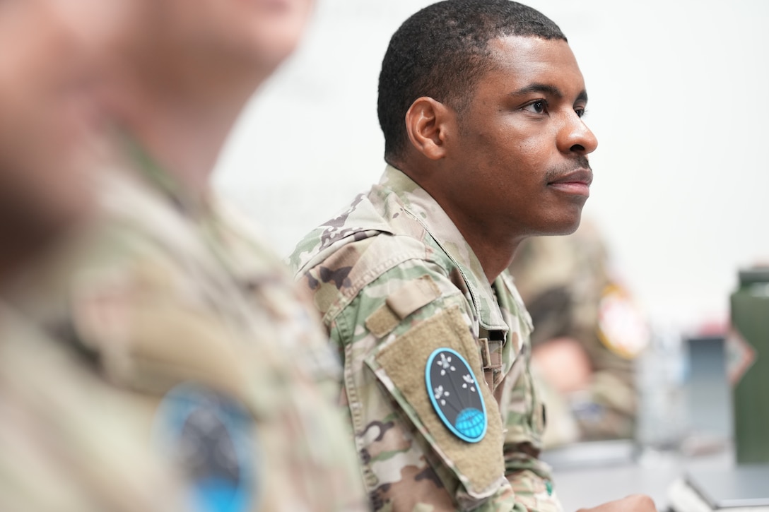 Capt. Malik McCoy, a Space Force student at Air University's Squadron Officer School, listens to a peer brief during his SPEAR Track experience, December 8, 2023. The program is designed to provide Space Force officers their own specialized training needed for Guardian leadership development. (U.S. Air Force photo by Billy Blankenship)