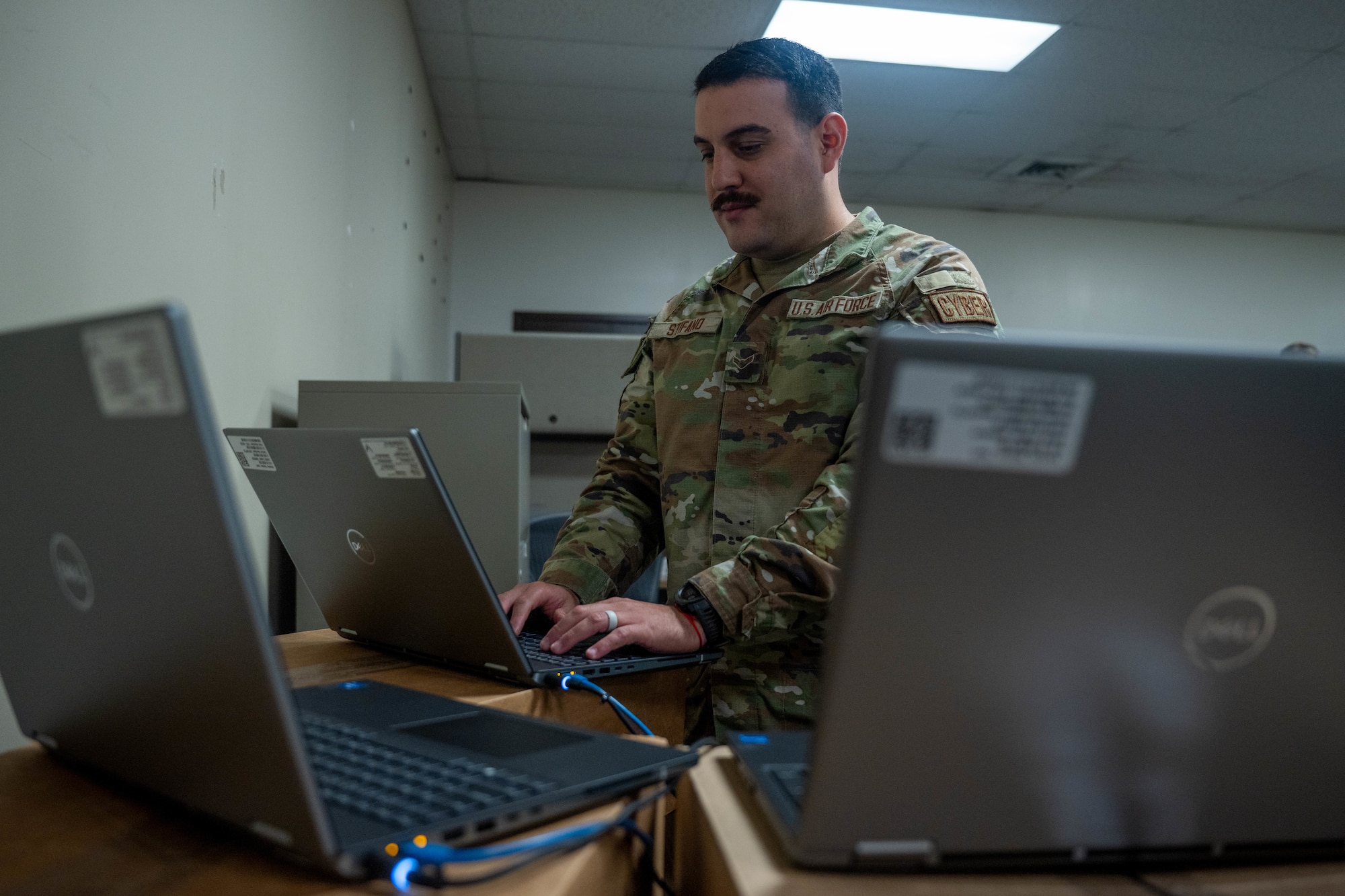 Airman 1st Class Michelangelo Stifano, 747th Cyberspace Squadron client systems technician, troubleshoots a computer at Joint Base Pearl Harbor-Hickam, Hawaii, Nov. 2, 2023. The 747th CYS leadership dispatched a specialized team that worked together to reduce the unit computer ticket queues across the installation. (U.S. Air Force photo by Senior Airman Makensie Cooper)