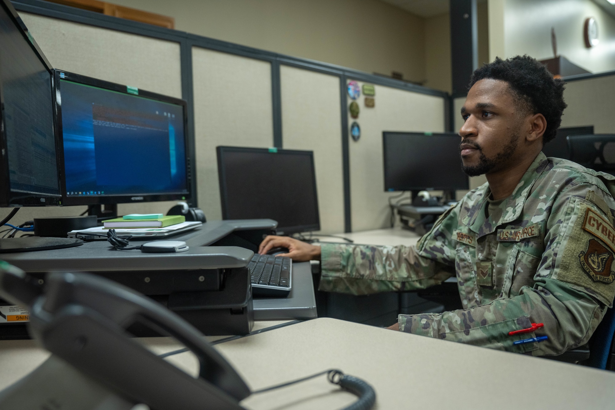 Senior Airman Kajhaun Roberts, 747th Cyberspace Squadron client systems technician, troubleshoots a computer at Joint Base Pearl Harbor-Hickam, Hawaii, Nov. 2, 2023. The 747th CYS leadership dispatched a specialized team that worked together to reduce the unit computer ticket queues across the installation. (U.S. Air Force photo by Senior Airman Makensie Cooper)