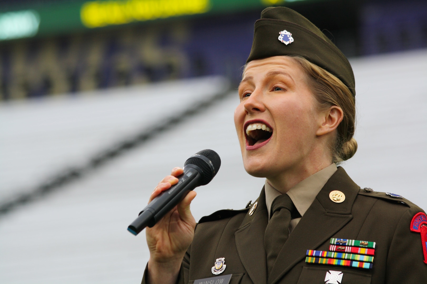 U.S. Army North 323d Army Band vocalist continues her service as she shares her talents by singing the National Anthem at a football game in Seattle, Wa. on Dec 1, 2023.