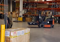 Shane Hall and Sgt. Jean Pascal Medigni look on as Pfc. Mamadou Aremou moves a pallet of patient monitors in the warehouse of the U.S. Army Medical Materiel Agency’s Medical Maintenance Operations Division at Hill Air Force Base, Utah, Nov. 14, 2023. (C.J. Lovelace)