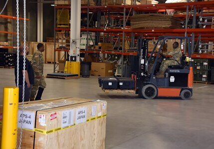 Shane Hall and Sgt. Jean Pascal Medigni look on as Pfc. Mamadou Aremou moves a pallet of patient monitors in the warehouse of the U.S. Army Medical Materiel Agency’s Medical Maintenance Operations Division at Hill Air Force Base, Utah, Nov. 14, 2023. (C.J. Lovelace)