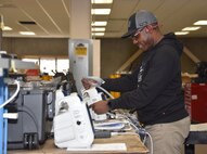 Godwin Gagah, a contract biomedical equipment technician at the U.S. Army Medical Materiel Agency’s Medical Maintenance Operations Division at Hill Air Force Base, Utah, performs maintenance on a patient monitor Nov. 14, 2023. Gagah also has served in the Army National Guard for 13 years. (C.J. Lovelace)