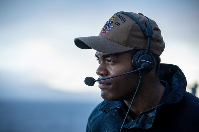 240105-N-LK647-1112 STRAIT OF GIBRALTAR (Jan. 5, 2024) Seaman Micah Cohen, from Jacksonville, Florida, assigned to the Ticonderoga-class guided missile cruiser USS Normandy (CG 60), stands starboard lookout, as the Ford Carrier Strike Group passes through the Strait of Gibraltar, Jan. 5, 2024. Normandy is part of the Gerald R. Ford Carrier Strike Group and is currently operating in the Mediterranean Sea, at the direction of the Secretary of Defense. The U.S. maintains forward-deployed, ready, and postured forces to deter aggression and support security and stability around the world. (U.S. Navy photo by Mass Communication Specialist 2nd Class Malachi Lakey)