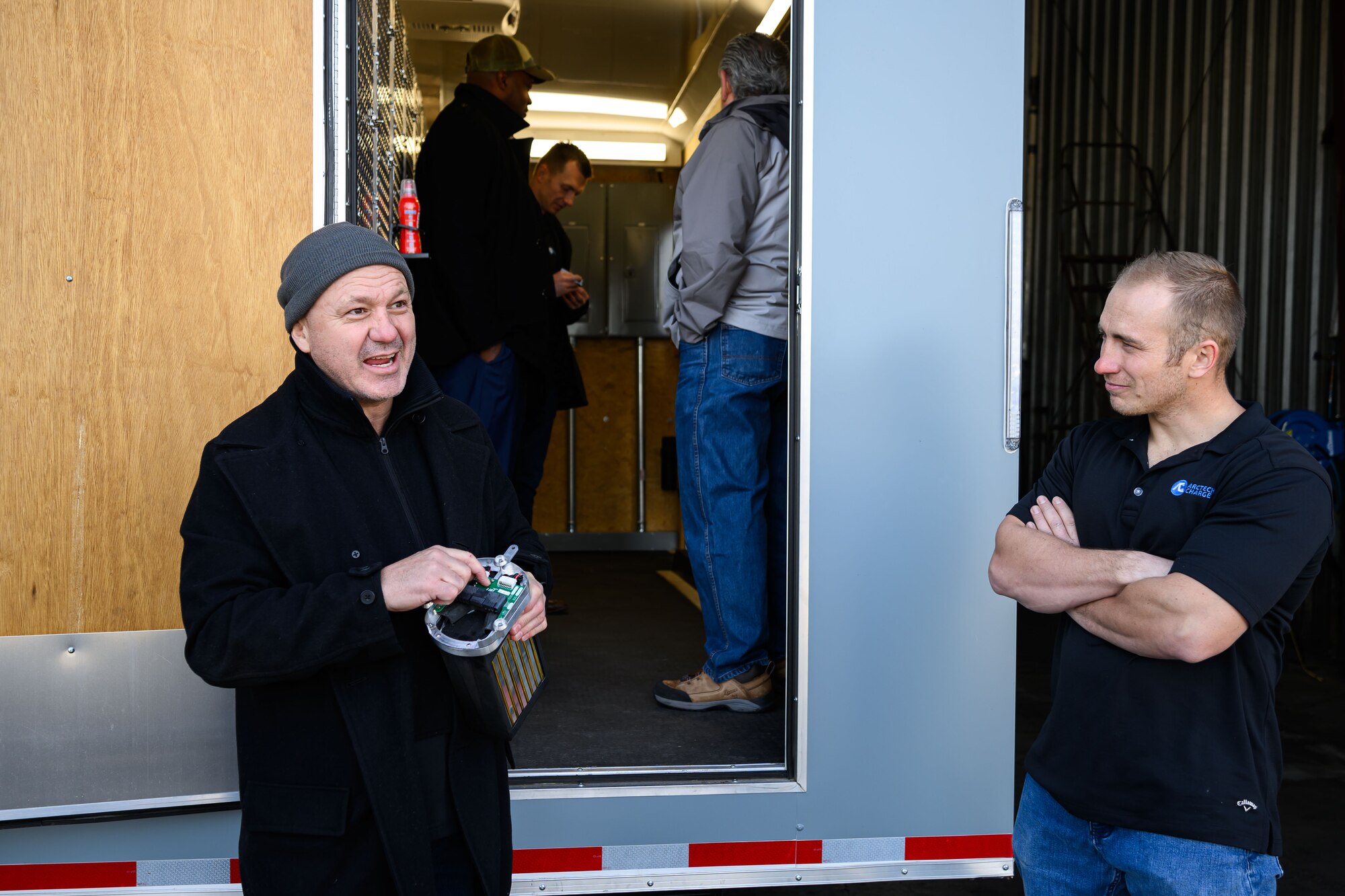 Gleason holds a battery during a demonstration of Arctech Charge's mobile battery management system.